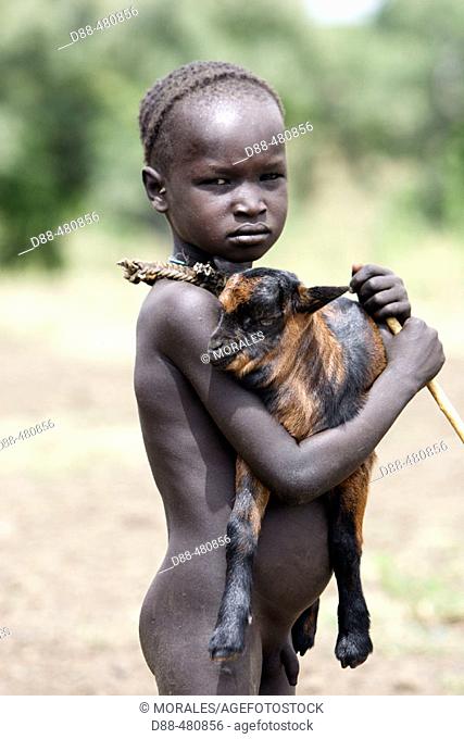 Mursi child with goat kid. Omo valley tribe. South Ethiopia
