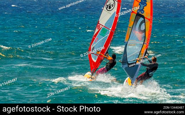 PAIA, UNITED STATES OF AMERICA - AUGUST 10 2015: close up of three windsurfers at the world famous ho'okipa beach, maui