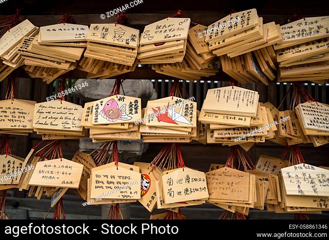 Fukuoka, Japan - September 13 2017: Wooden prayer tablets with Japanese characters and pictures in Kushida shrine in Japan
