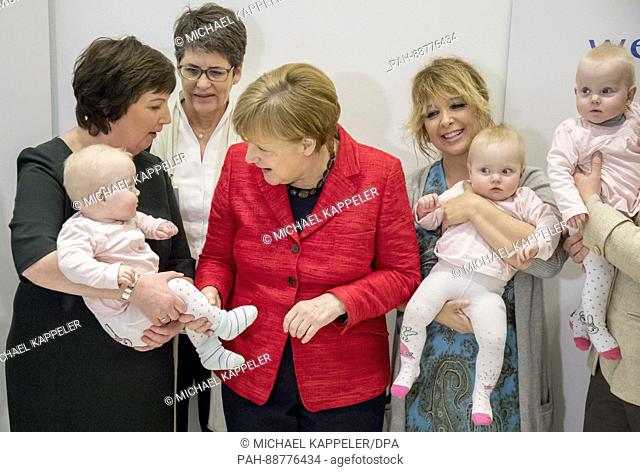 German chancellor Angela Merkel (CDU) with the ten-month-old baby Romy at an event celebrating the 15th anniversary of the children's charity wellcome founded...