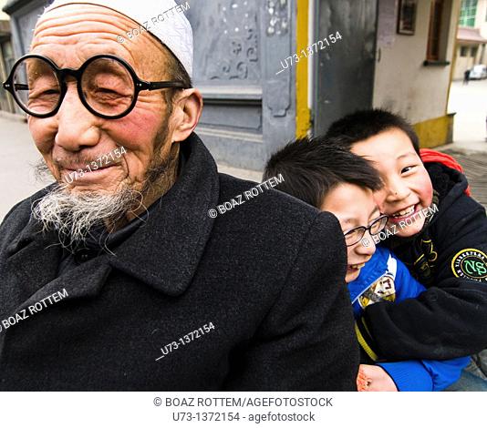 A Hui Muslim man with his two grandchildren