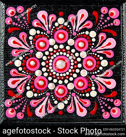 Mandala dot art painting on wood tiles. Beautiful mandala hand painted by colorful dots on black wood. National patterns with acrylic paints, handwork