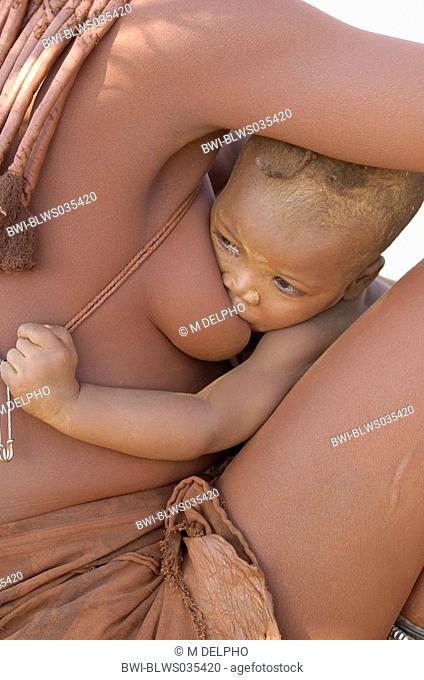 Himba woman nursing child, Namibia