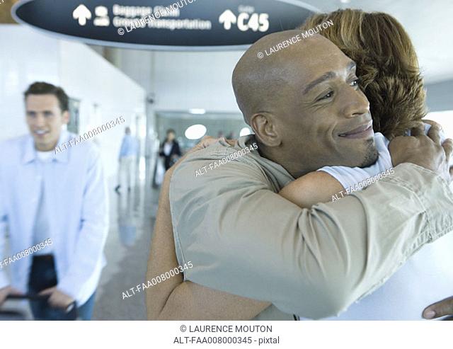 Couple hugging in airport