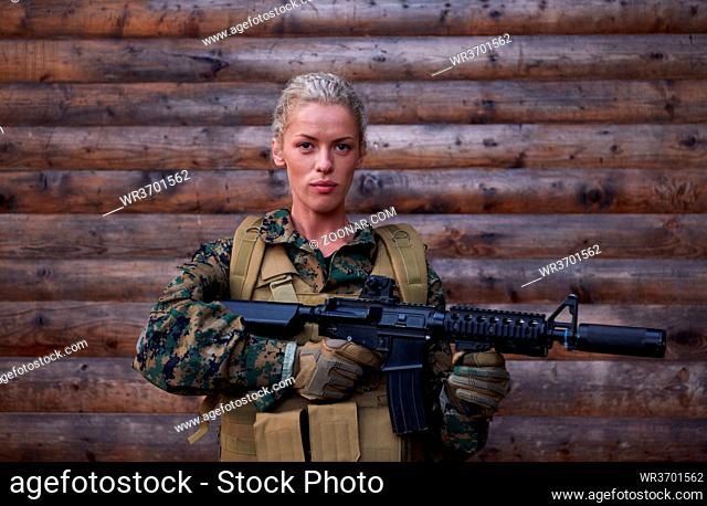 woman soldier ready for battle wearing protective military gear and weapon