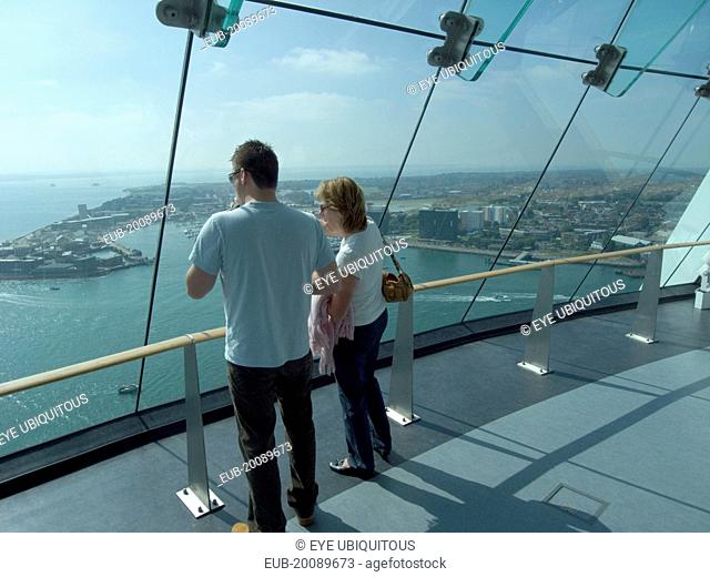 Gunwharf Quays. The Spinnaker Tower. Interior view with visitors looking out of glass windows on the top observation deck