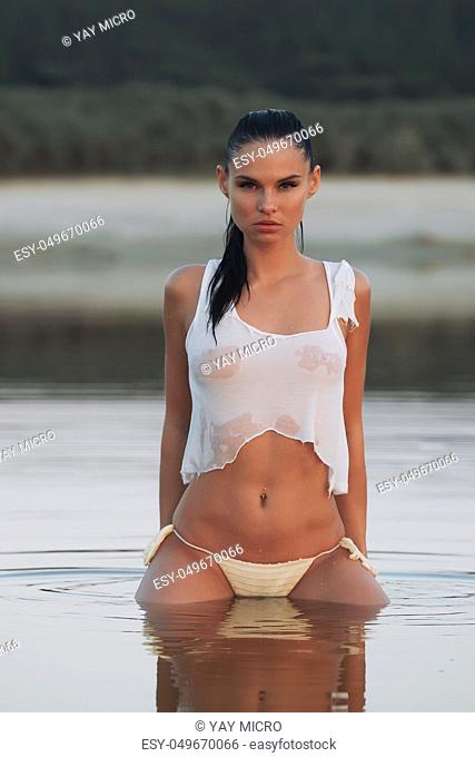 Girl in swimsuit at the sea. High fashion look.glamor beautiful sexy stylish blond. Caucasian young woman model