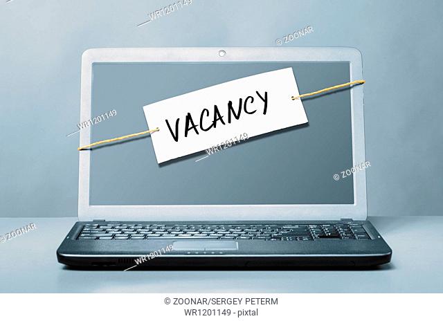 laptop with vacancy note
