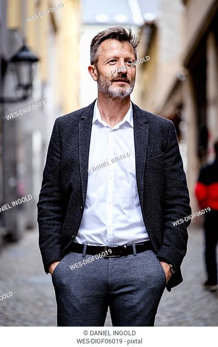 Portrait of mature businessman with greying beard in the city