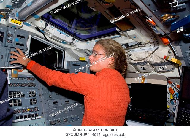 Canadian Space Agency astronaut Julie Payette, STS-127 mission specialist, works controls on the aft flight deck of the Earth-orbiting Space Shuttle Endeavour...