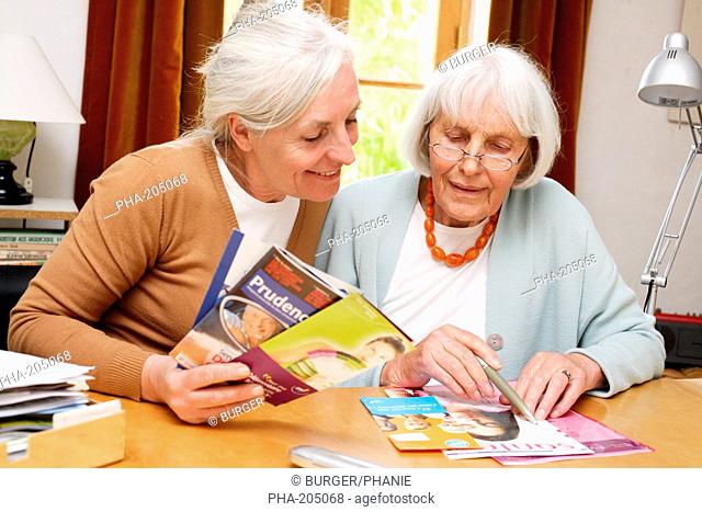 Elderly woman reading information leaflet