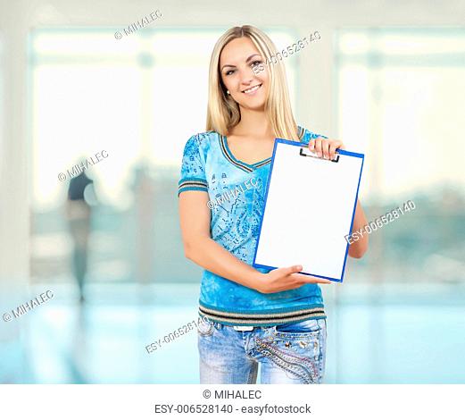 a smiling female holding empty clopboard