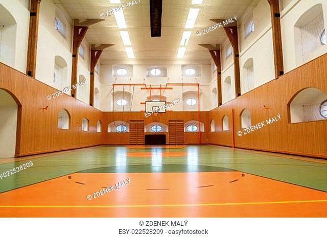 Empty interior of public gym with basketball court