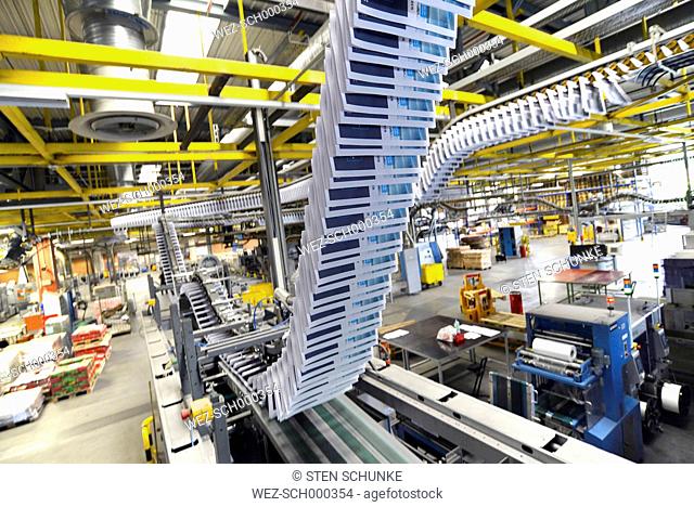 Conveyor belt with brochures in a printing shop