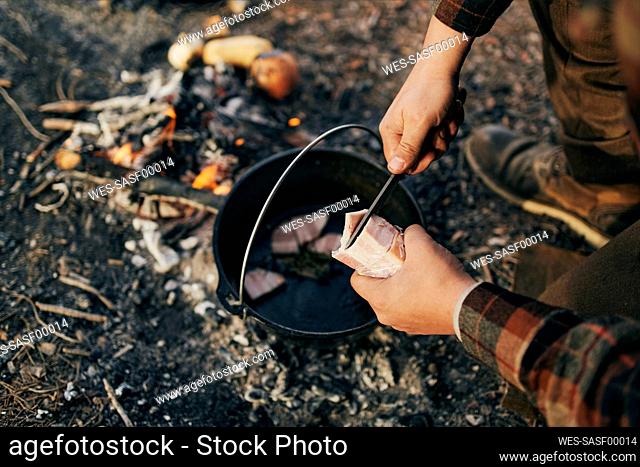 Bushcrafter cooking in forest