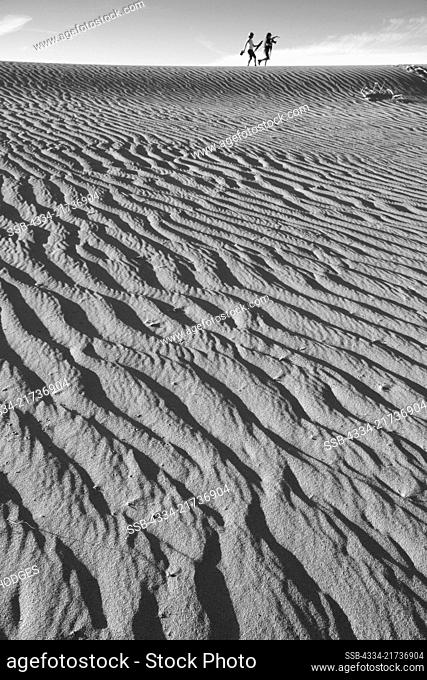 Hikers and Wind Blown Sand Ridges in the Mesquite Sand Dunes in Death Valley National Park in California