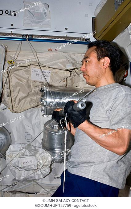 Japan Aerospace Exploration Agency astronaut Satoshi Furukawa, Expedition 28 flight engineer, uses the short bar for the advanced Resistive Exercise Device...