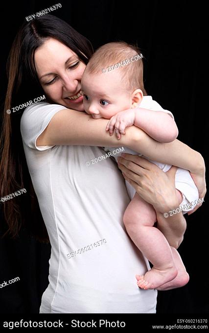 Beautiful mother hugs her baby. Motherhood