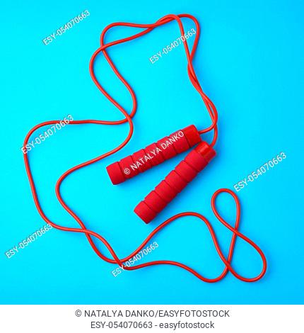red rope for sports on a blue background, two neoprene handle