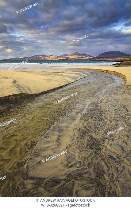 The stream on Luskentyre Beach on the Isle of Harris, with the hills of North Harris in the distance captured on a stormy afternoon in late October