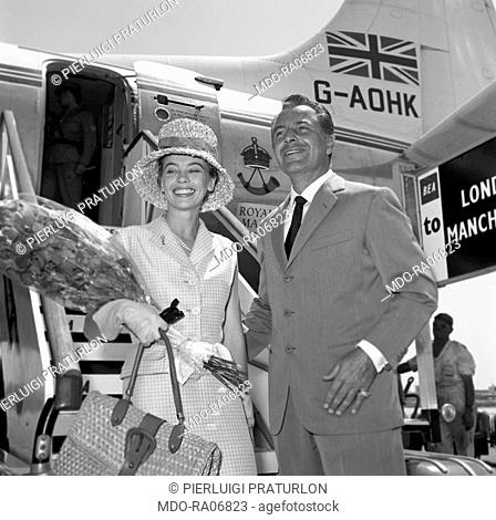 Italian actor Rossano Brazzi welcoming French actress Leslie Caron who just landed at Ciampino airport. Rome, 24th July 1959