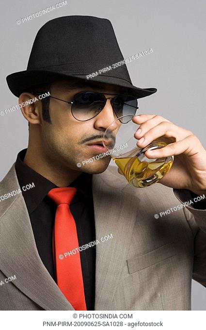 Actor portraying a businessman drinking wine