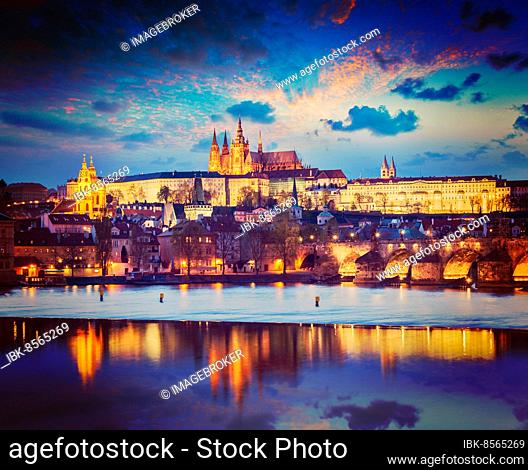 Vintage retro hipster style travel image of Prague Europe concept background, view of Charles Bridge and Prague Castle in twilight