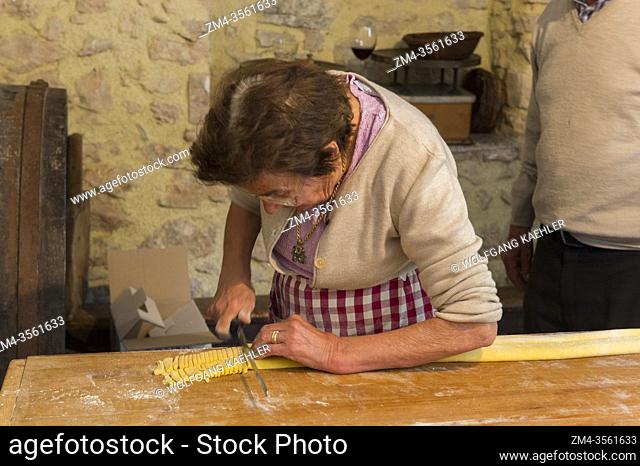 A senior woman is making fettuccine in Pettino, a small village in the mountains near Campello sul Clitunno in the Province of Perugia, Umbria, central Italy