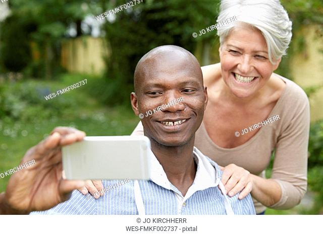 Portrait of couple taking selfie with smartphone