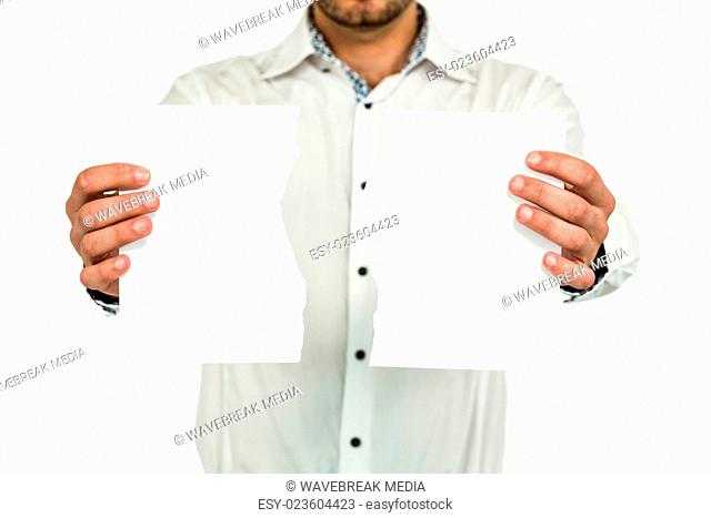 Standing man showing torn papers