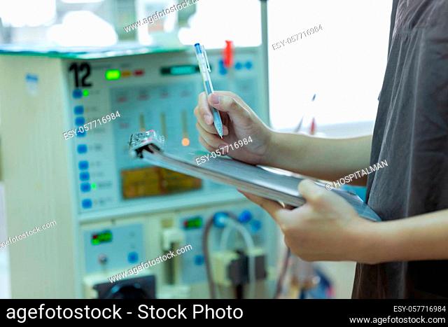 The specialist are checking continuous renal replacement therapy equipment and injection pump and hemodialysis machine