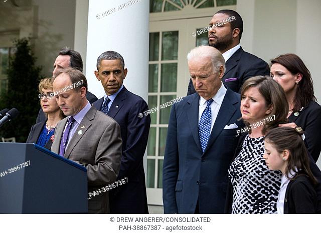 United States President Barack Obama looks on as Mark Barden speaks after gun legislation failed in Congress, in the Rose Garden at the White House