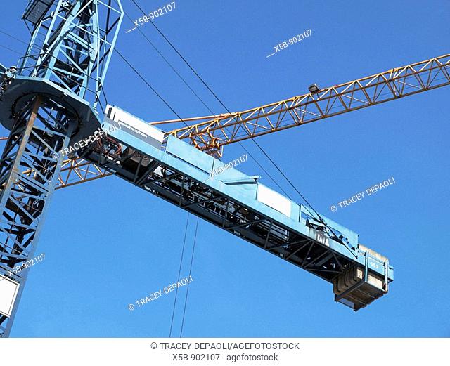 New building construction cranes crossing in the blue sky  Port Coquitlam, British Columbia, Canada