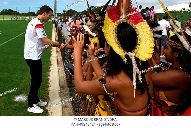A group of Brazilian indigenous talks to German team manager Oliver Bierhoff during an open training session for fans and spectators of the German national...