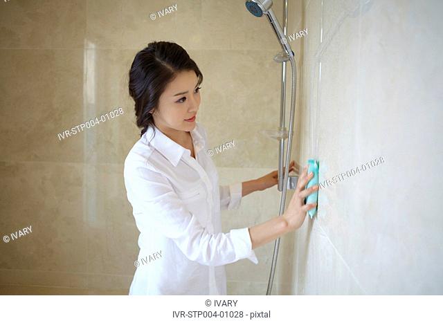 Woman Washing Bathroom Tiles