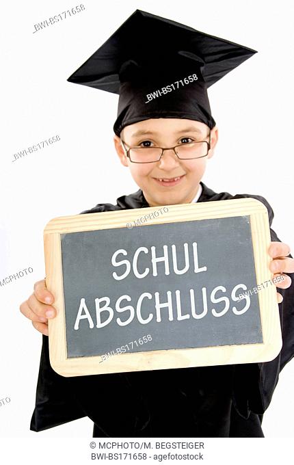 symbolic for school graduation. Small boy as diploma holder with a blackboard