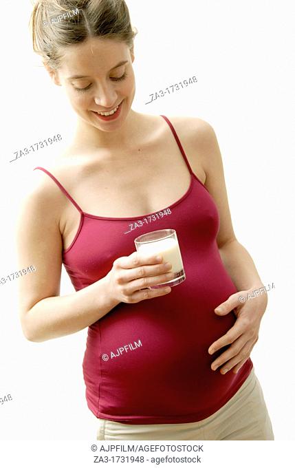 Pregnant woman at full term drinking milk