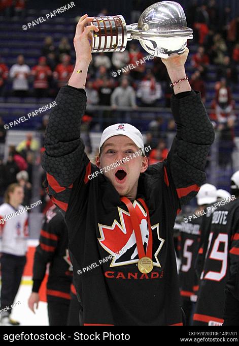 Happy Canadian player Bowen Byram poses with gold medal and winner's trophy after his team won the 2020 IIHF World Junior Ice Hockey Championships