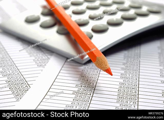 financial accounting with table sheet, red pencil and calculator