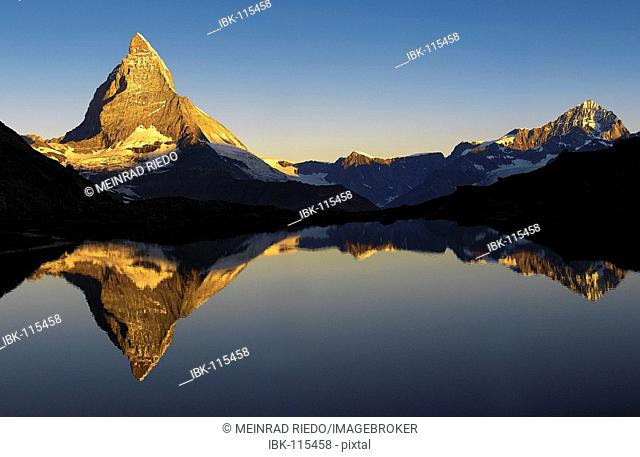 The Matterhorn is reflected in the Riffelsee near Zermatt, canton Wallis, Switzerland