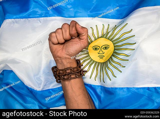 Fists that break the chains on the Argentine flag. Argentine revolution and independence concept