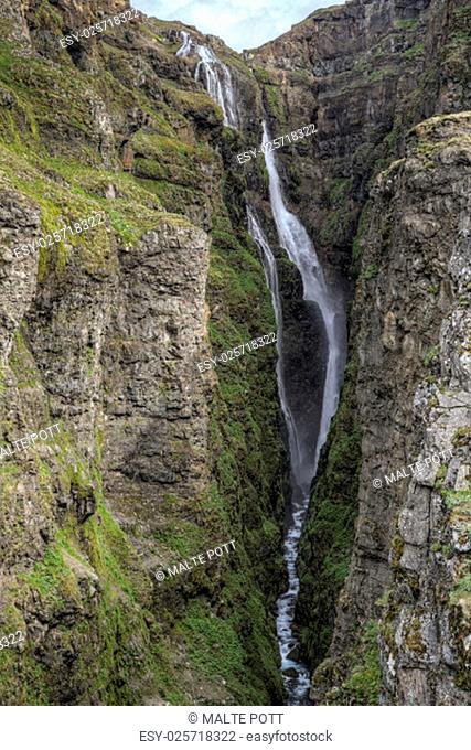the picture shows the glymur, one of the highest waterfalls in iceland