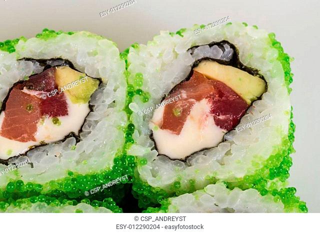 Tobiko Spicy Maki Sushi - Hot Roll with various type of Tobiko (flying fish roe) outside. Tuna, avocado and Green Lettuce inside