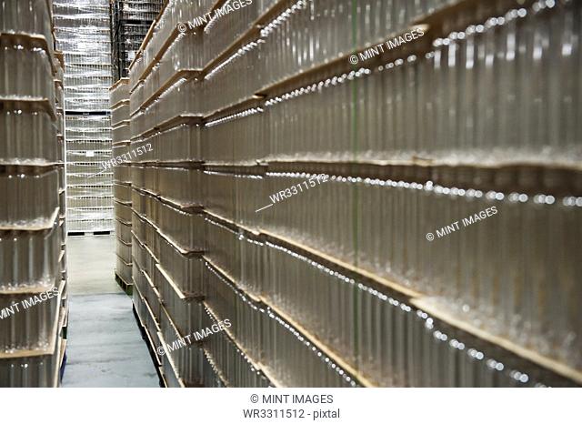 Glass bottles stacked in warehouse