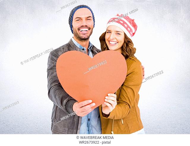 Smiling couple holding a heart