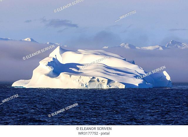 Huge iceberg, evening light, clearing mist, Bransfield Strait, near South Shetland Islands and Antarctic Peninsula, Antarctica, Polar Regions