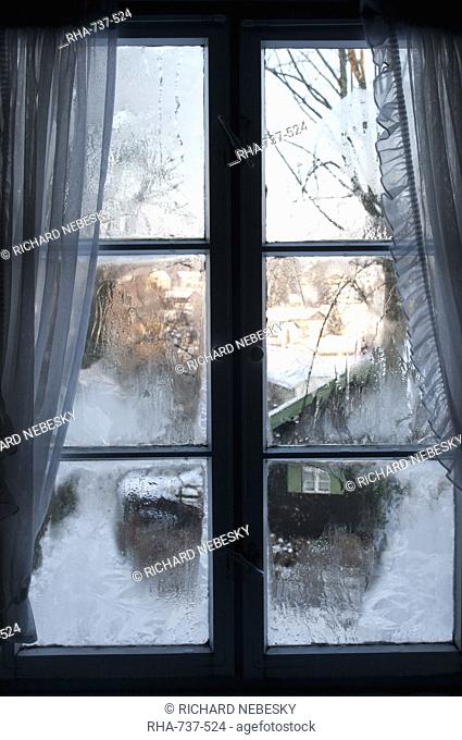 View of Bad Tolz spa town covered by snow at sunrise from window, Bavaria, Germany, Europe