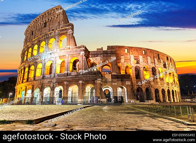 The Colosseum illuminated at sunrise, front view, Rome, Italy