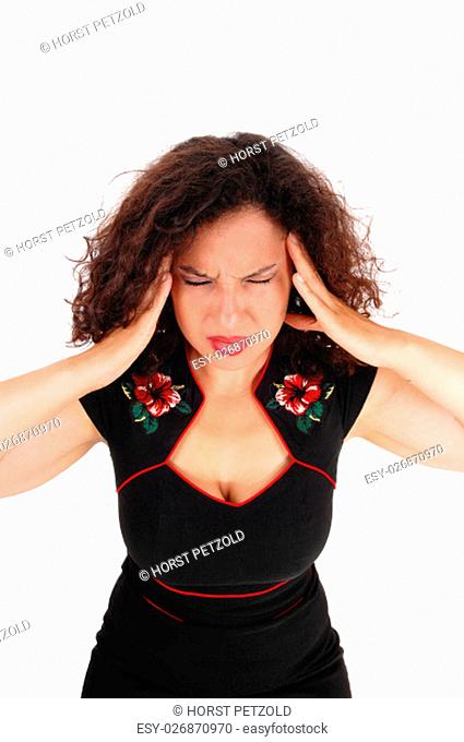 A closeup image of a pretty woman in a black dress holding booths hands.on her head for migraine pain, isolated for white background.