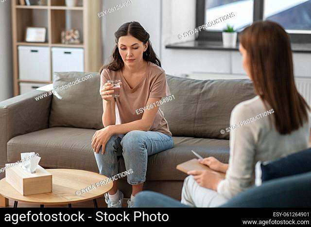 woman and psychologist at psychotherapy session